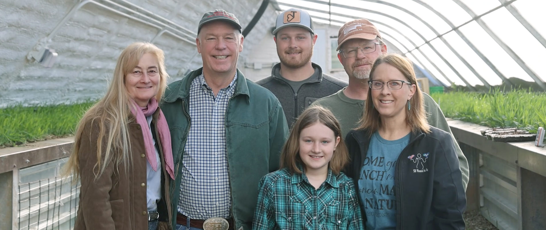 Greg and Susan Gianforte with people in greenhouse