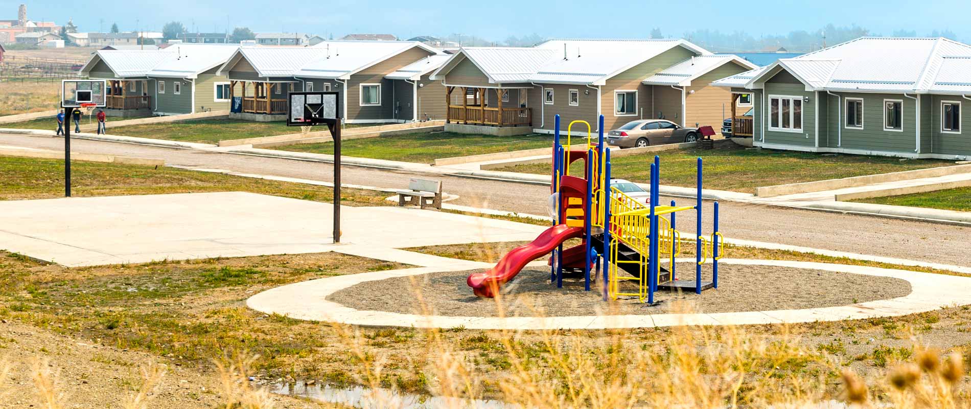 Homes with playground and basketball court in front